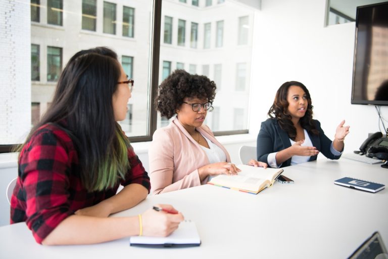 A group of diverse educators sitting at a table in discussion